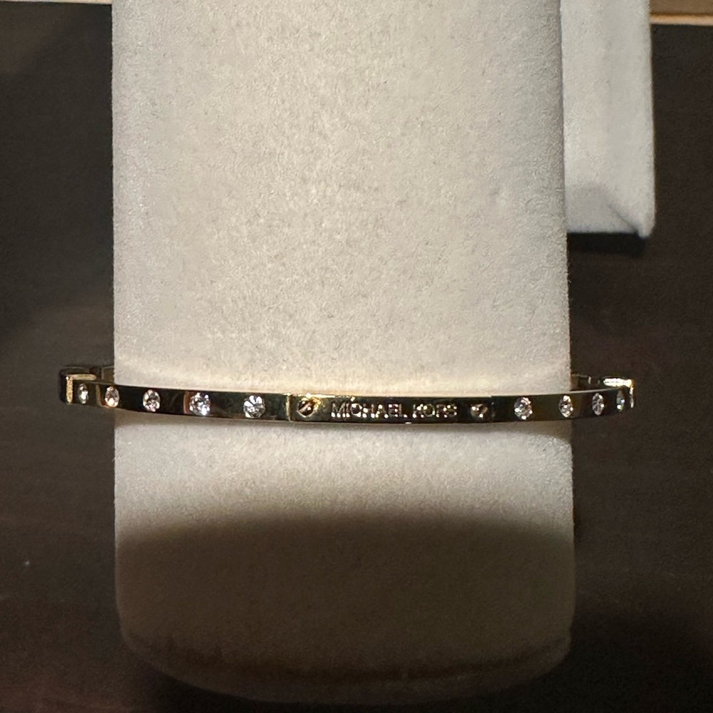 Beautiful gold tone Michael Kors bangle bracelet with rhinestones.